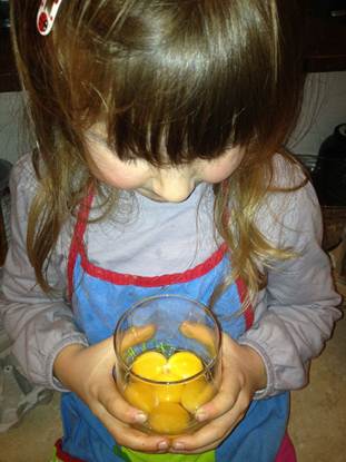 Anna holding glass of cracked eggs