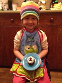 Anna holding freshly baked and frosted Bulletproof cupcake