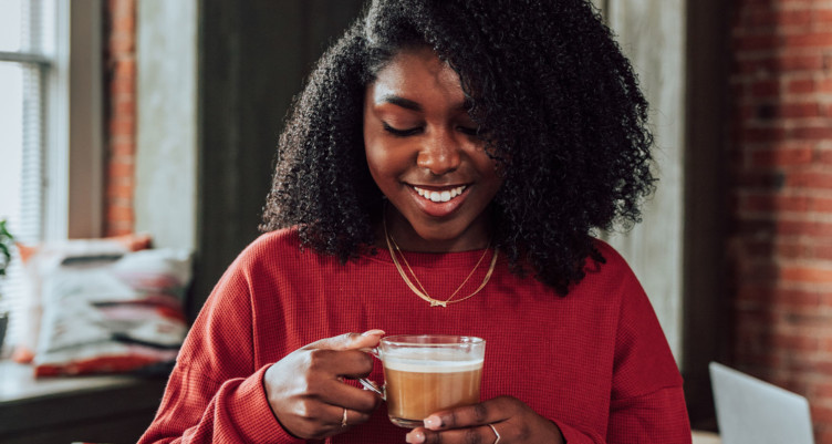 Woman holding mug of Bulletproof Coffee