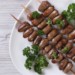 Chicken hearts on skewers with parsley