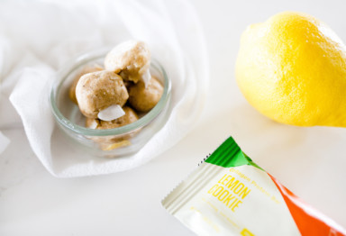 A bag of snacks with a lemon and snack bar