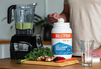 Person scooping collagen into smoothie
