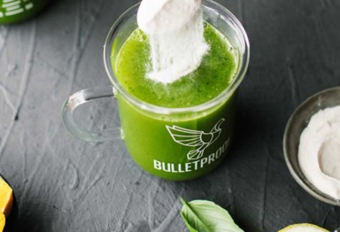 Scoop of collagen in green juice