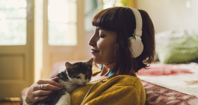 Woman relaxing while listening to cat talking