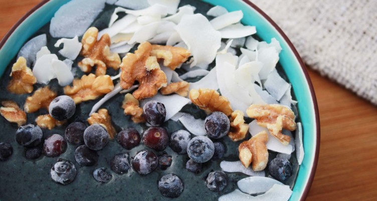 smoothie bowl topped with berries nuts and coconut