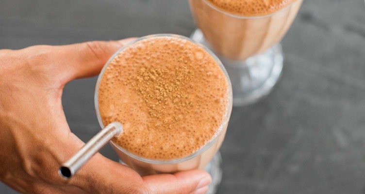 hand holding chocolate milkshake