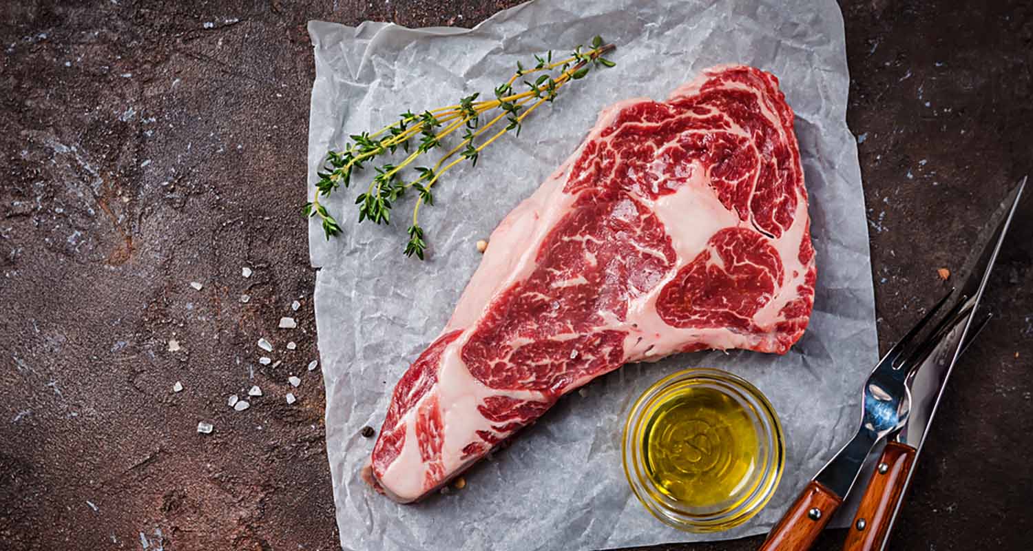 Raw cut of steak with thyme