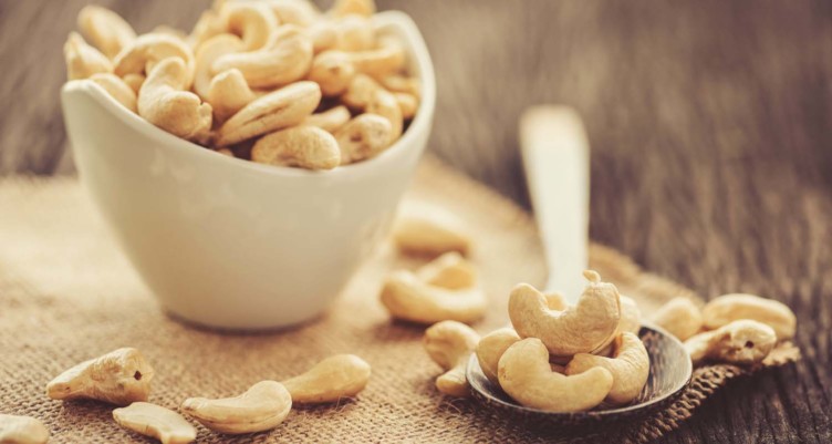 Cashews on a spoon and in a bowl