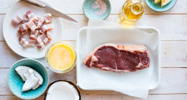 Raw steak next to coconut oil and ghee