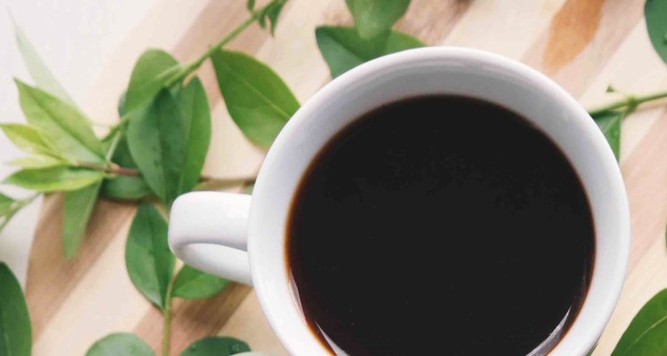 Cup of black coffee in white mug