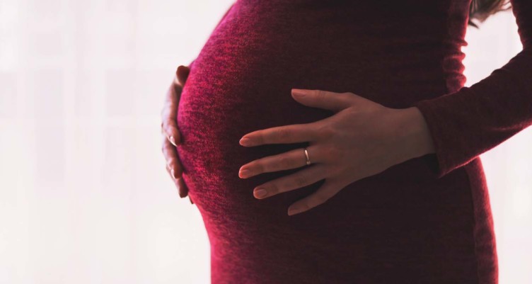woman holding pregnant belly