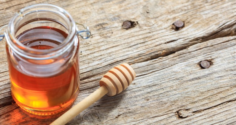 A glass jar of honey