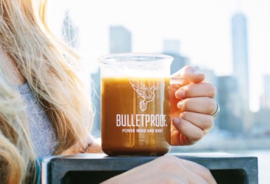 Woman holding beaker of Bulletproof Coffee