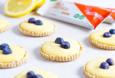 Smooth and summery sugar free lemon curd meets a crumbly vanilla crust in this simple low-carb recipe for mini tarts. Perfect for dessert!