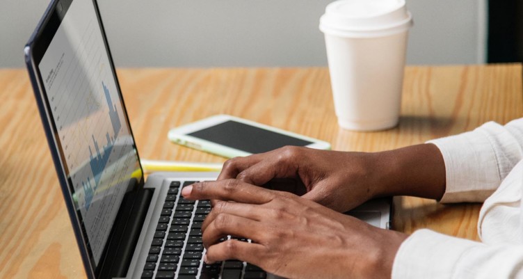 Person typing at computer