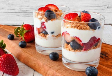 Red, white and blue themed parfait featuring strawberries, blueberries, Bulletproof Vanilla Shortbread Collagen Bars and yogurt