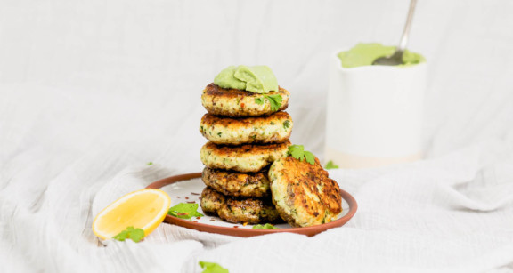 Stack of keto fish cakes with avocado lemon sauce