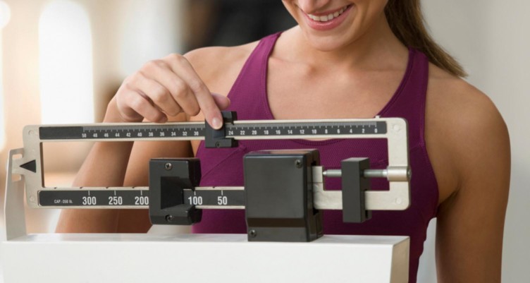 Woman adjusting scale