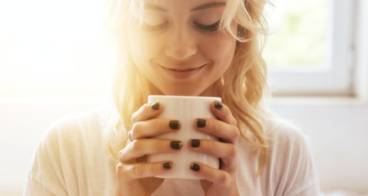Woman holding cup of coffee