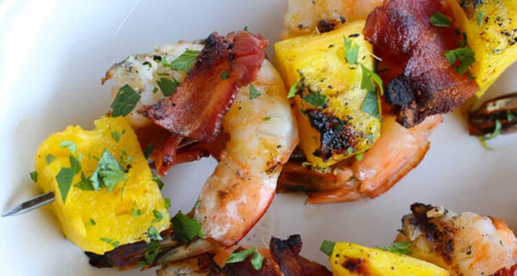 Juicy pineapple and crisp bacon surround chunks of succulent shrimp in this low carb Bacon Pineapple Shrimp Skewers recipe. Perfect for summer!