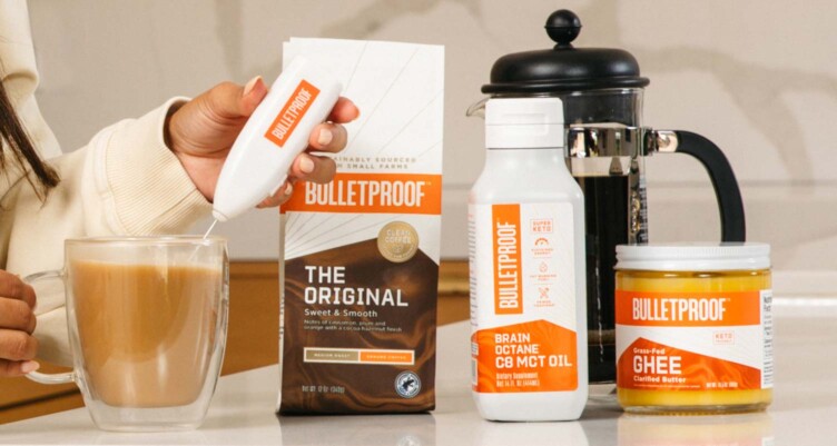 Woman frothing Bulletproof coffee next to to coffee, Brain Octane C8 MCT Oil, & Grass-Fed Ghee