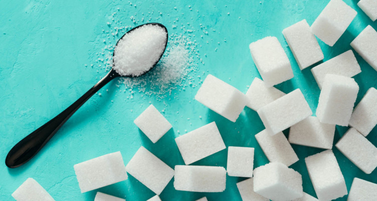 Cubes of sugar next to spoon