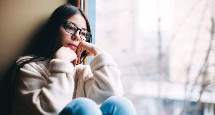 Woman sitting next to window