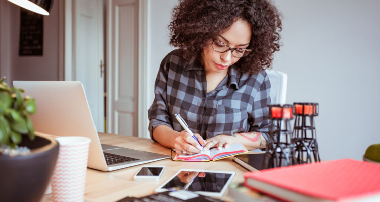 Woman writing in food journal