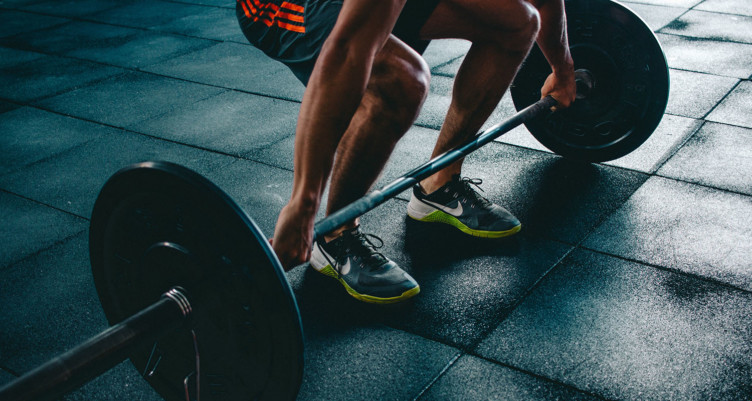 Person doing deadlifts in gym