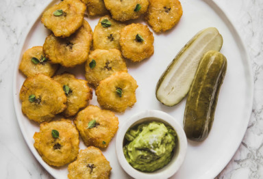 Plate of tostones with pickles and guacamole