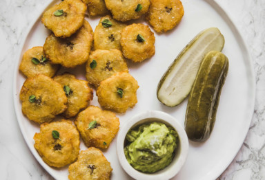 Plate of tostones with pickles and guacamole