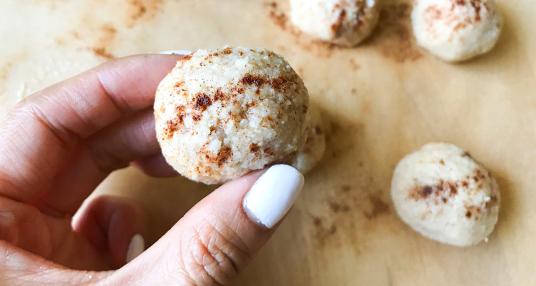 hand holding cinnamon protein balls