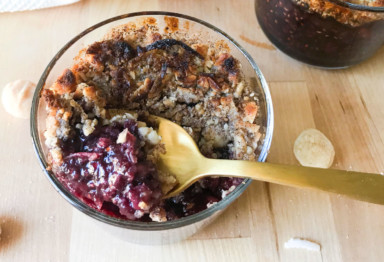 This sweet paleo berry cobbler recipe is packed with protein and healthy fats -- all without grains, gluten, or refined sugar. (Plus just 15 minutes prep!)