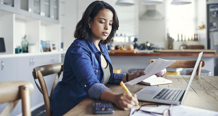 Woman working at kitchen table