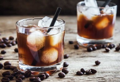 Two glasses of a Keto White Russian Recipe surrounded by coffee beans