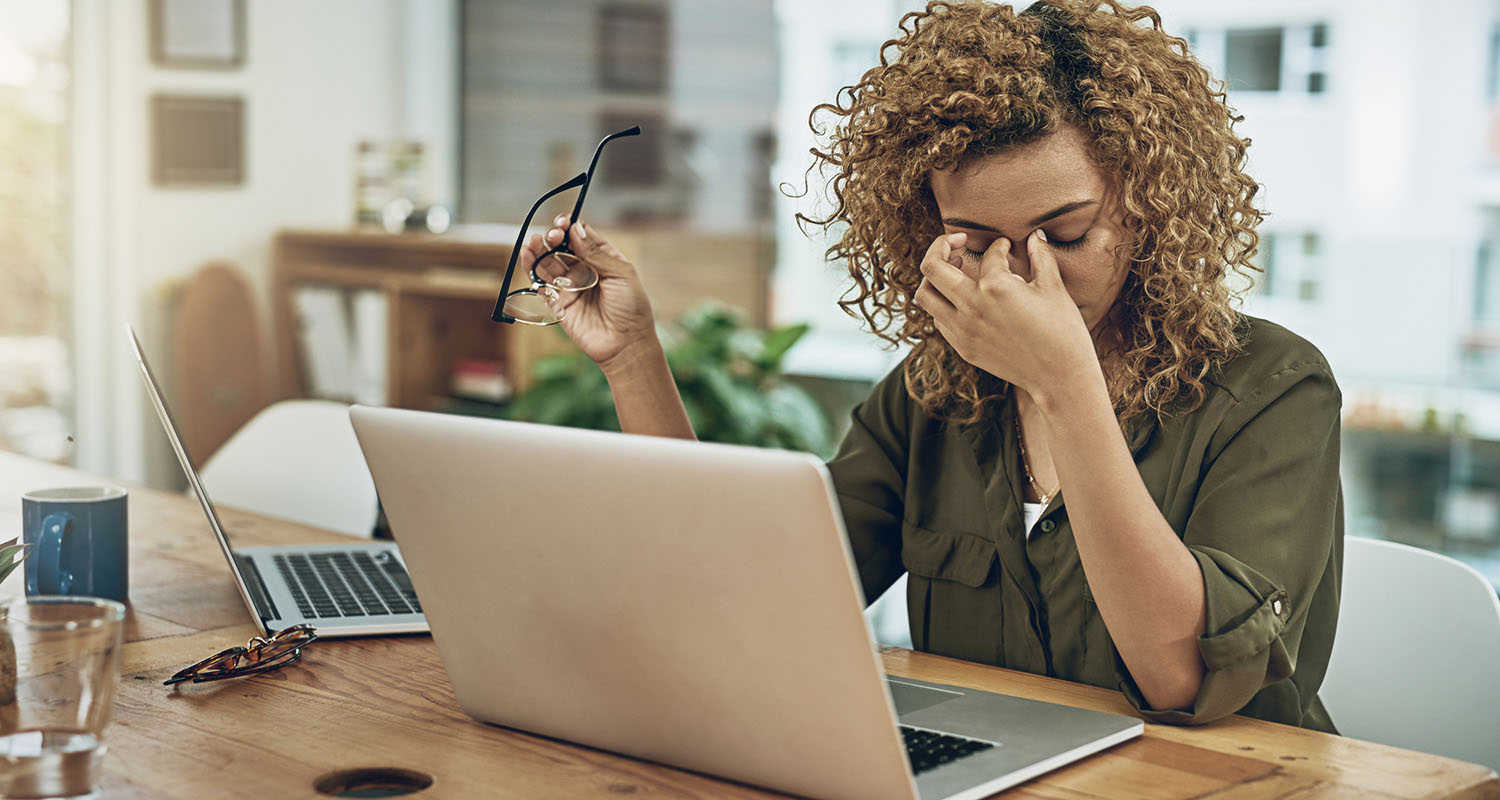 Person sitting at desk looking tired