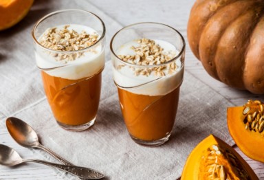 Two pumpkin smoothies topped with oats