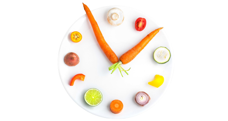 Carrots and vegetables on plate in shape of clock