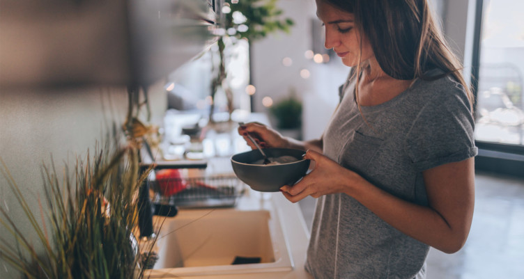 Woman eating from bowl