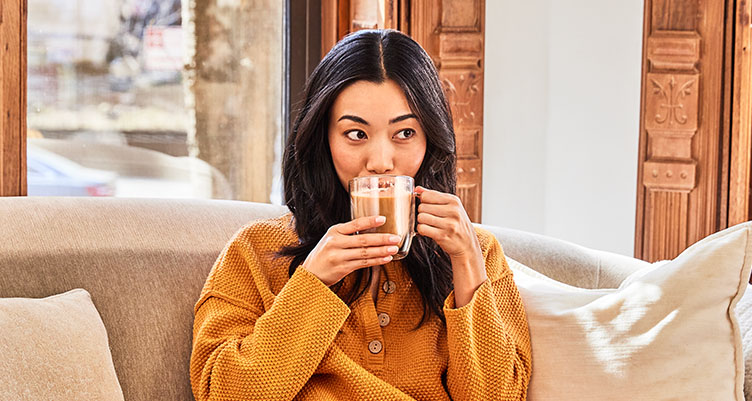 https://www.bulletproof.com/wp-content/uploads/2018/10/girl-sitting-couch-original-coffee-recipe-752.jpg