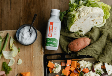Bottle of Bulletproof MCT Oil surrounded by vegetables
