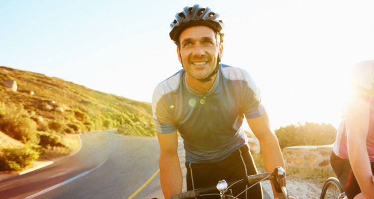 Man riding bike in sunlight