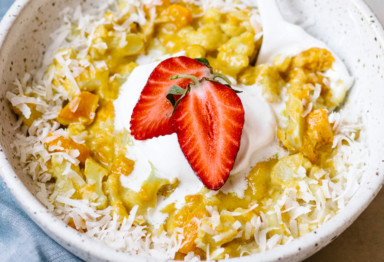 Bowl of paleo pumpkin oatmeal topped with strawberry