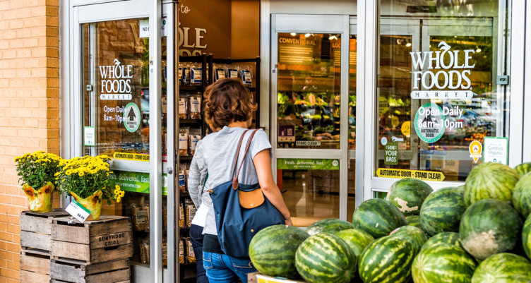 Woman walking into Whole Foods