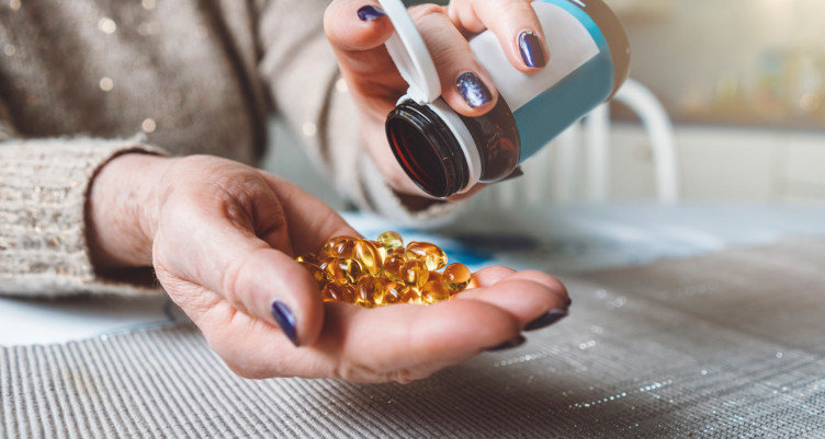 Pouring vitamins into palm