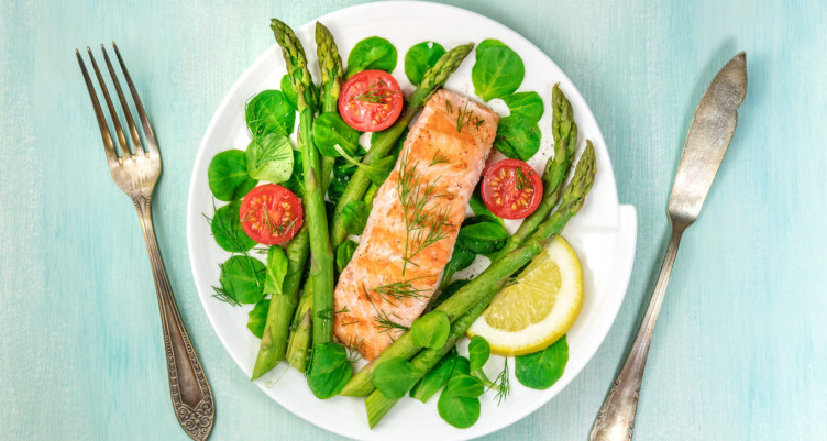 Salmon filet and vegetables on white plate
