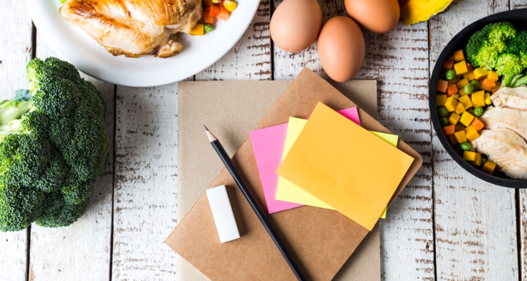 Notebook on table next to food