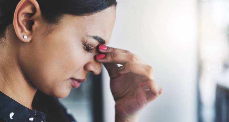 Woman holding bridge of nose