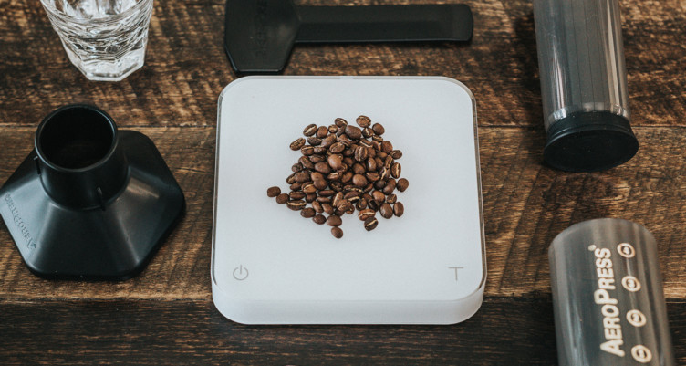 Overhead view of coffee beans and Aeropress