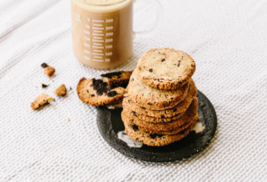 Stack of keto chocolate chip cookies on white tablecloth